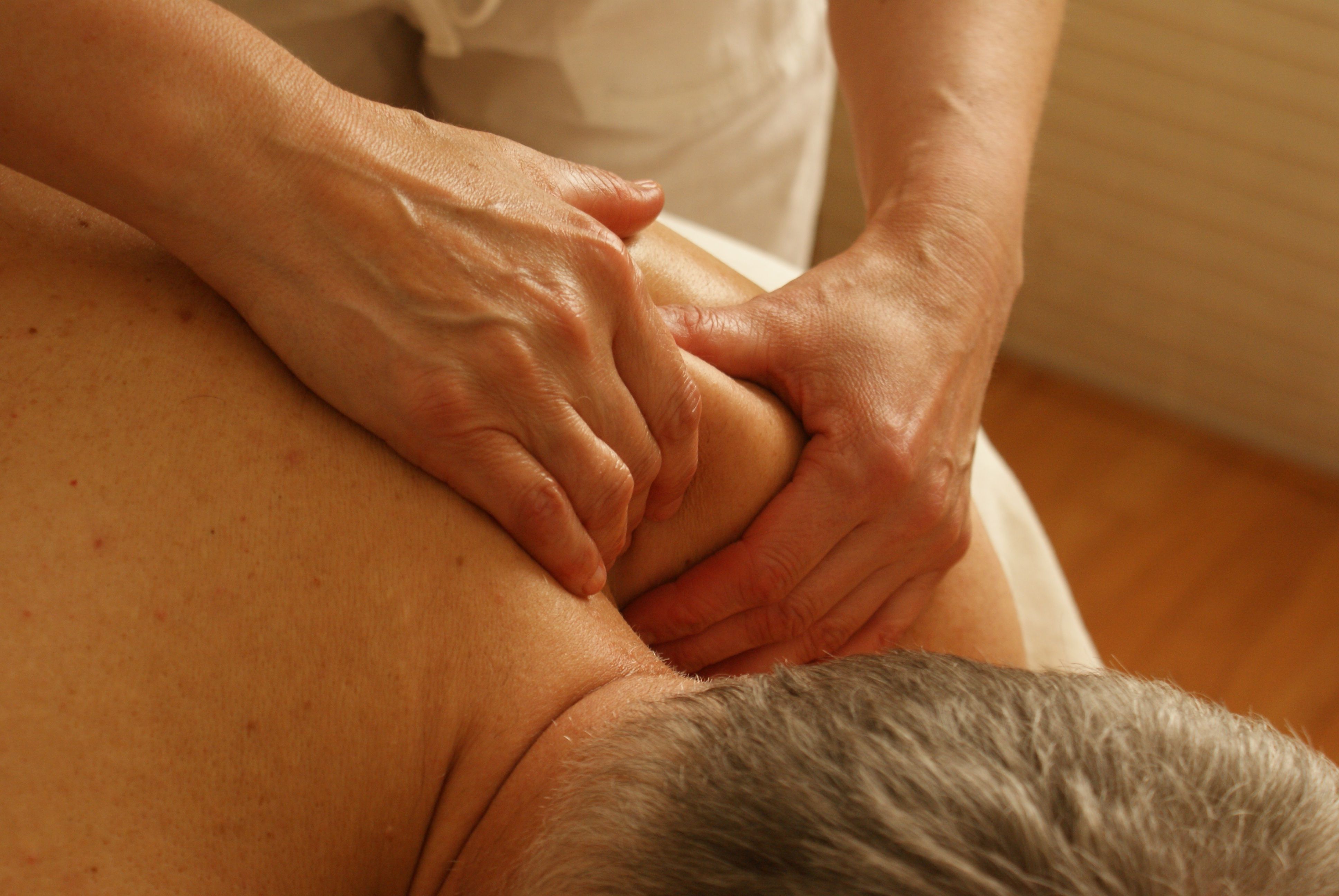 real photo of deep tissue work on a client's back/shoulders in the studio